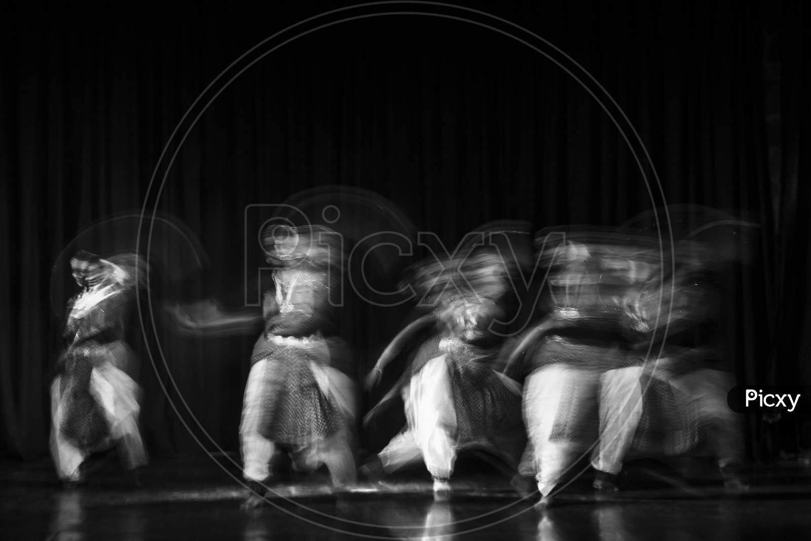 An Artistic Dancer In A Theater Shot With A Slow Shutter Speed In Order To Achieve The Desired Motion Blur.