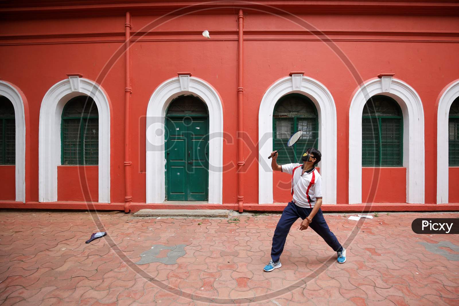 A man plays badminton outside a government building after the state eased lockdown norms during the nationwide lockdown to prevent the spread of coronavirus (COVID-19) in Bangalore, India.