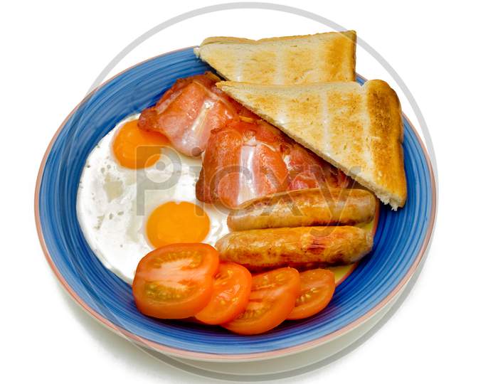 Typical English breakfast with eggs bacon sausage tomatoes and toast.