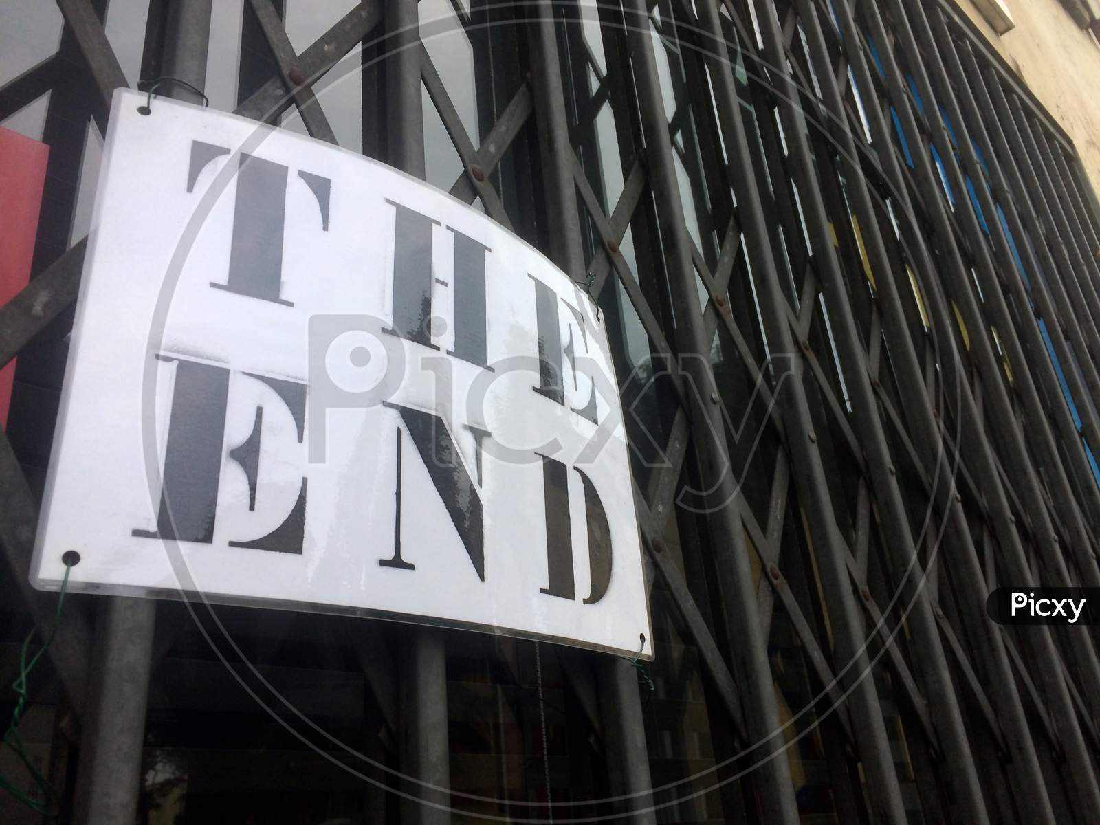 The End Sign Hanging In Front Of A Closed Store