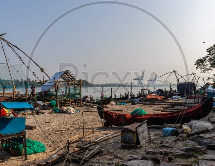 Fisherman And Its Fishing Nets In The Morning Hours At Kochi Kerala Cost