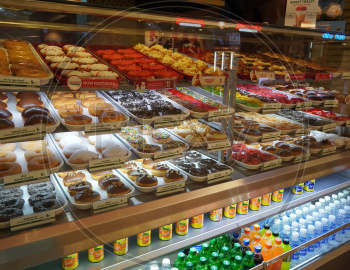 Variety Of Delicious Donut In Showcase On Display At Bakery Cake Shop Krispy Kreme. Various Donuts Type On Shelf In Bakery Shop. Selection Of Sweets. - Dubai Uae December 2019