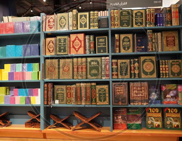 Stack Of Quran On The Shelf. Quran Religious Book Stacked In Shelf For Sale. Available In Various Languages In A Book Store. Islamic Books For Sale, Arabic Religion. Dubai Uae 7 December 2019