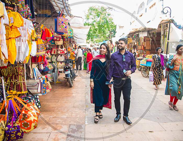 Pushkar, Rajasthan, India - November 14, 2019: Indian Couple Walking In Local Indian Street Market.