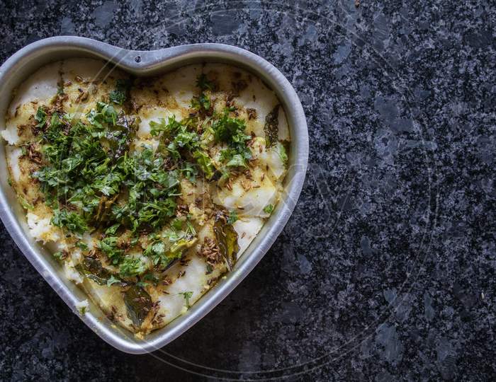 Dhokla In A Heart Shaped Bowl With Gray Granite Background