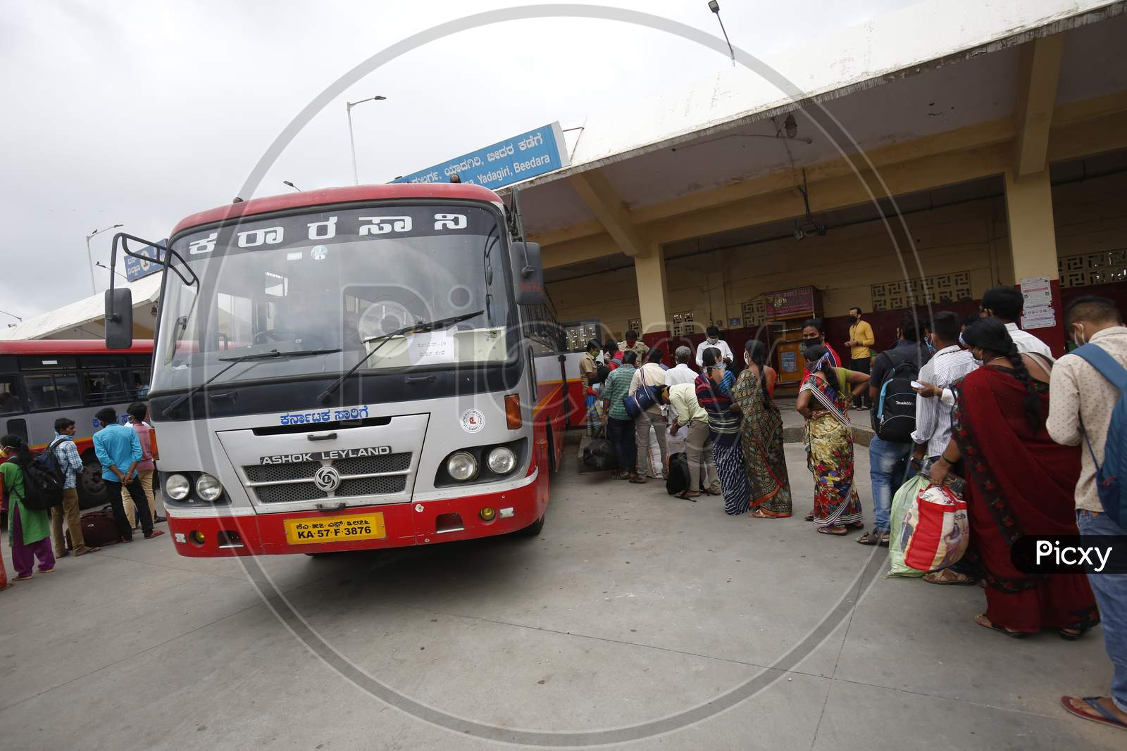 People board public transport buses in a bus station after the state eased lockdown norms during the nationwide lockdown to prevent the spread of coronavirus (COVID-19) in Bangalore, India.