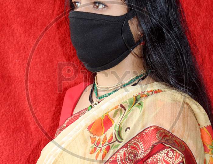 Portrait of housewife in corona virus. Young Hindu woman wear protective mask on face