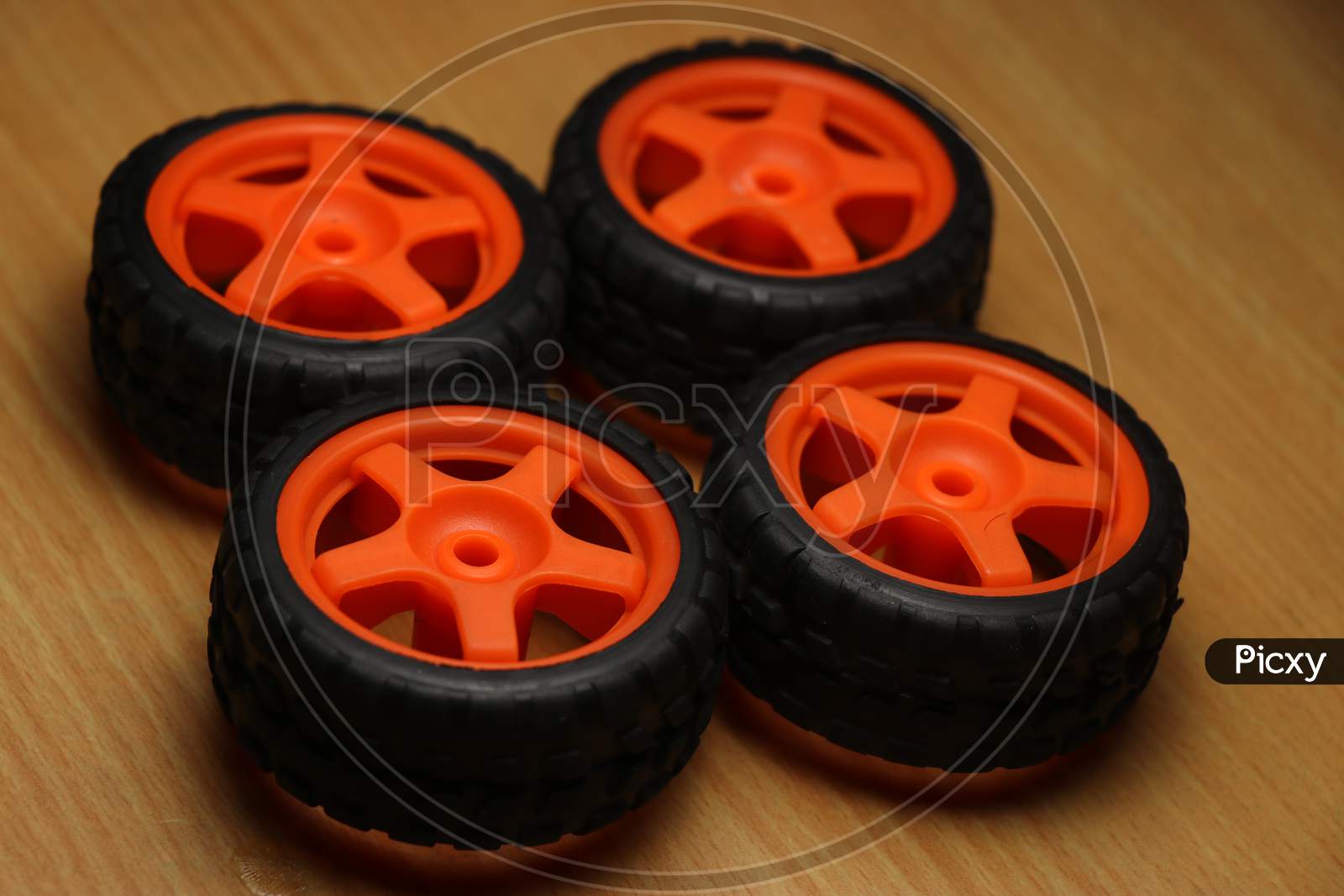 Wheels Of Remote Controlled Car On A Wooden Background