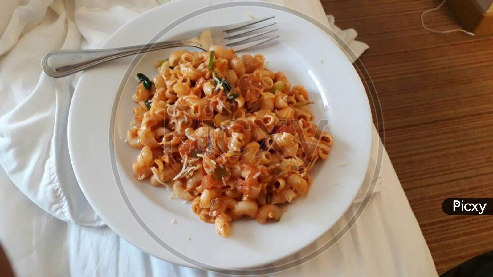 red sauce vegetable cheese pasta served hot on plate