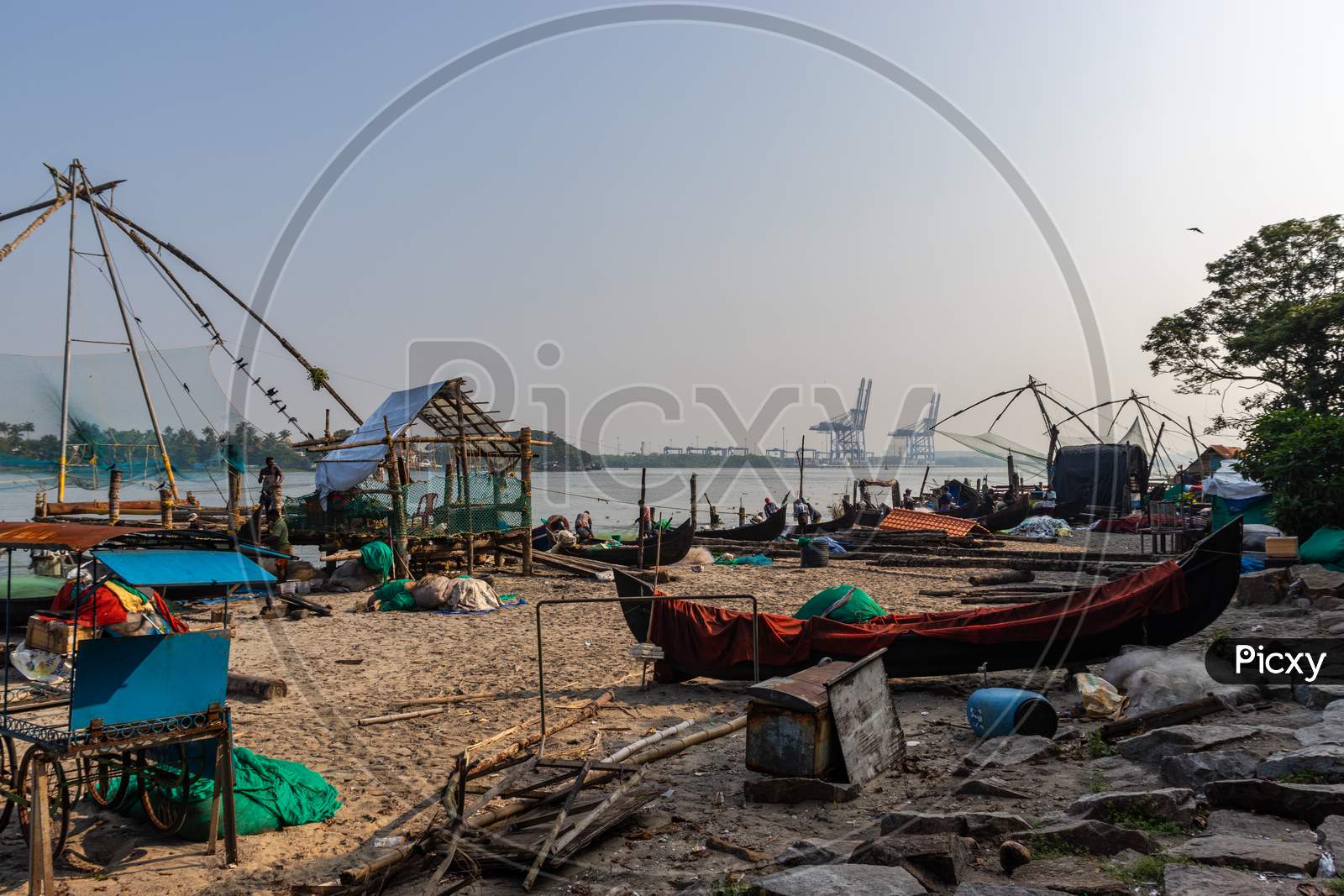 Fisherman And Its Fishing Nets In The Morning Hours At Kochi Kerala Cost