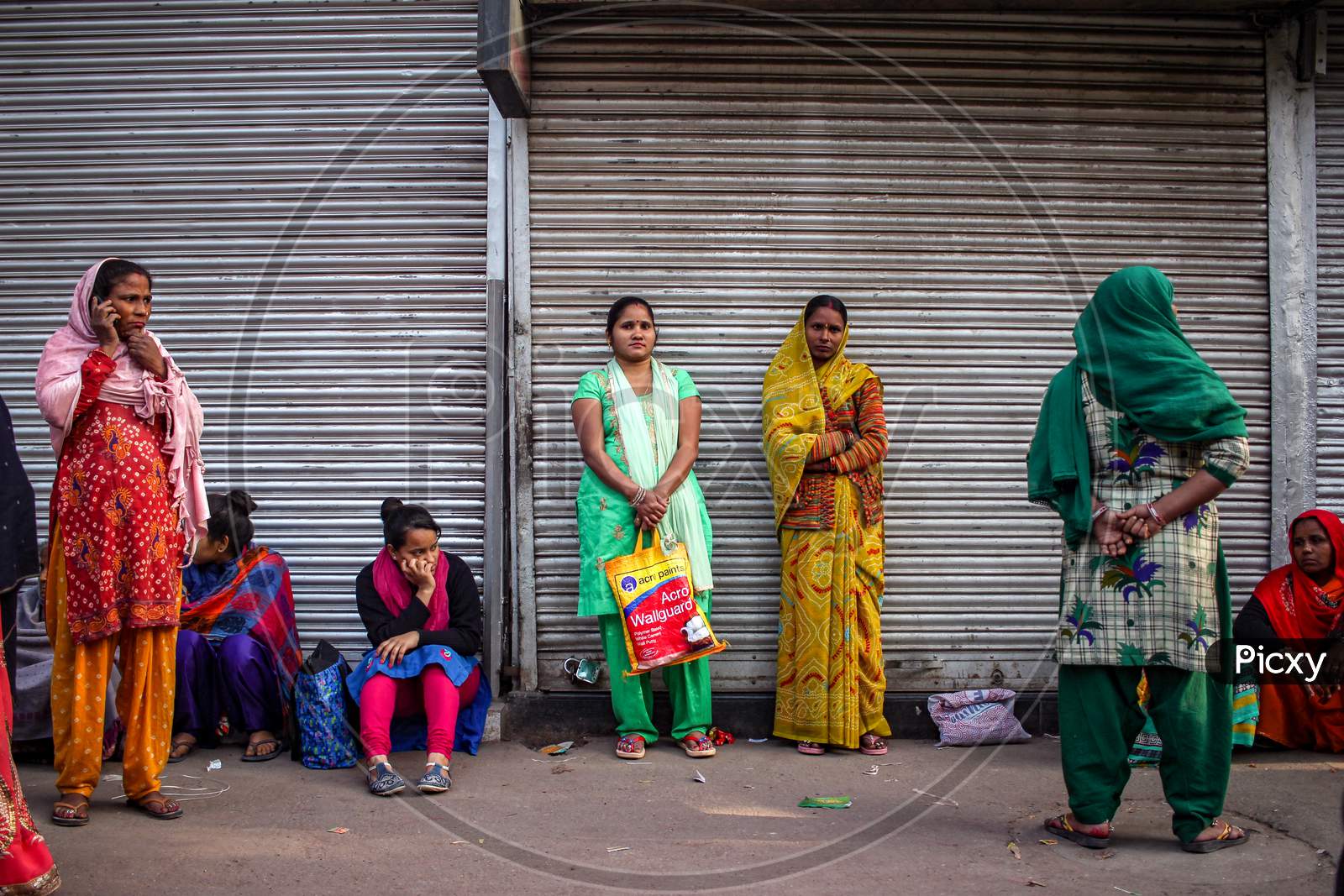 People Waiting At The Bus Stop With Their Children To Get Migrated By The Government During Corona Virus Epidemic.