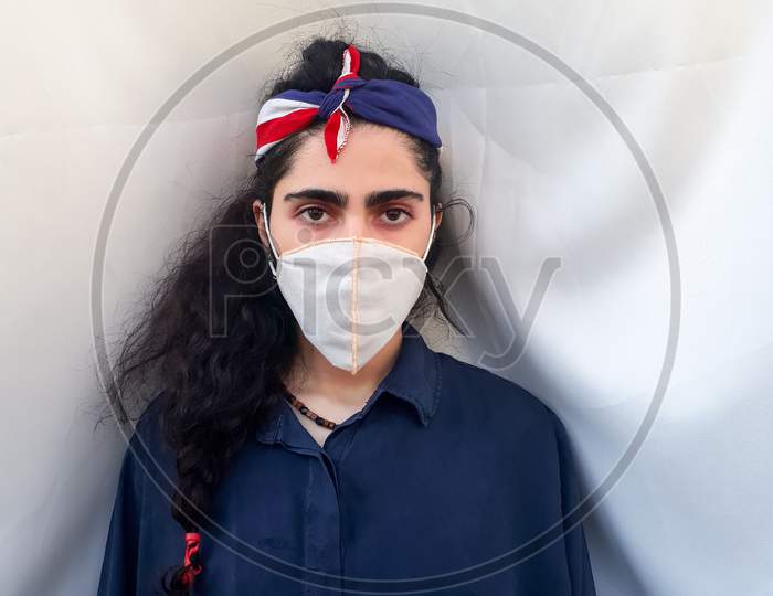 Photo of a young Iranian girl wearing coronavirus mask during lockdown days