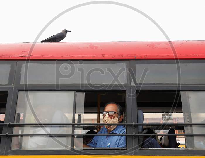 A passenger looks out of a public transport bus after the state eased lockdown norms during the nationwide lockdown to prevent the spread of coronavirus (COVID-19) in Bangalore, India.