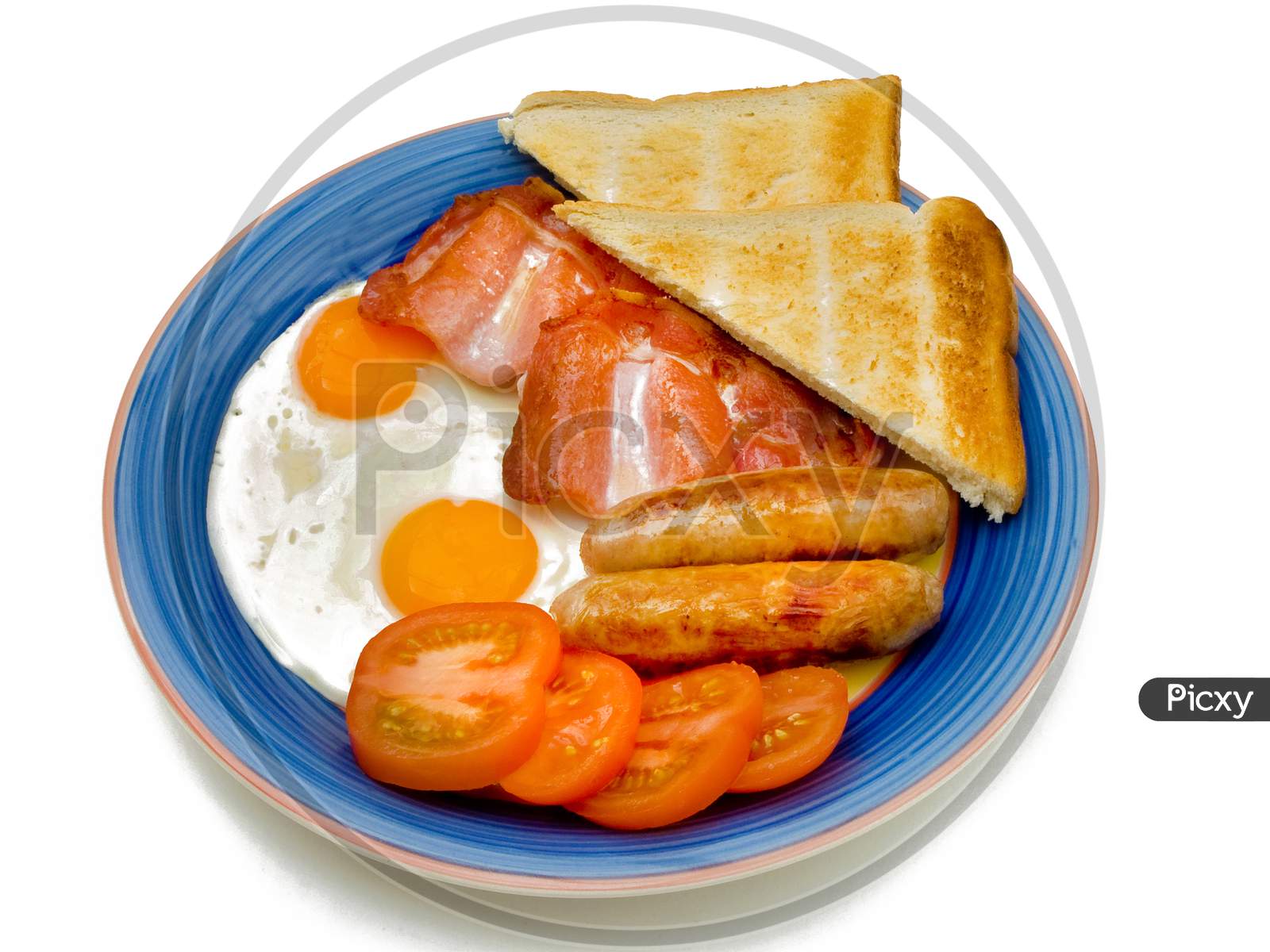 Typical English breakfast with eggs bacon sausage tomatoes and toast.