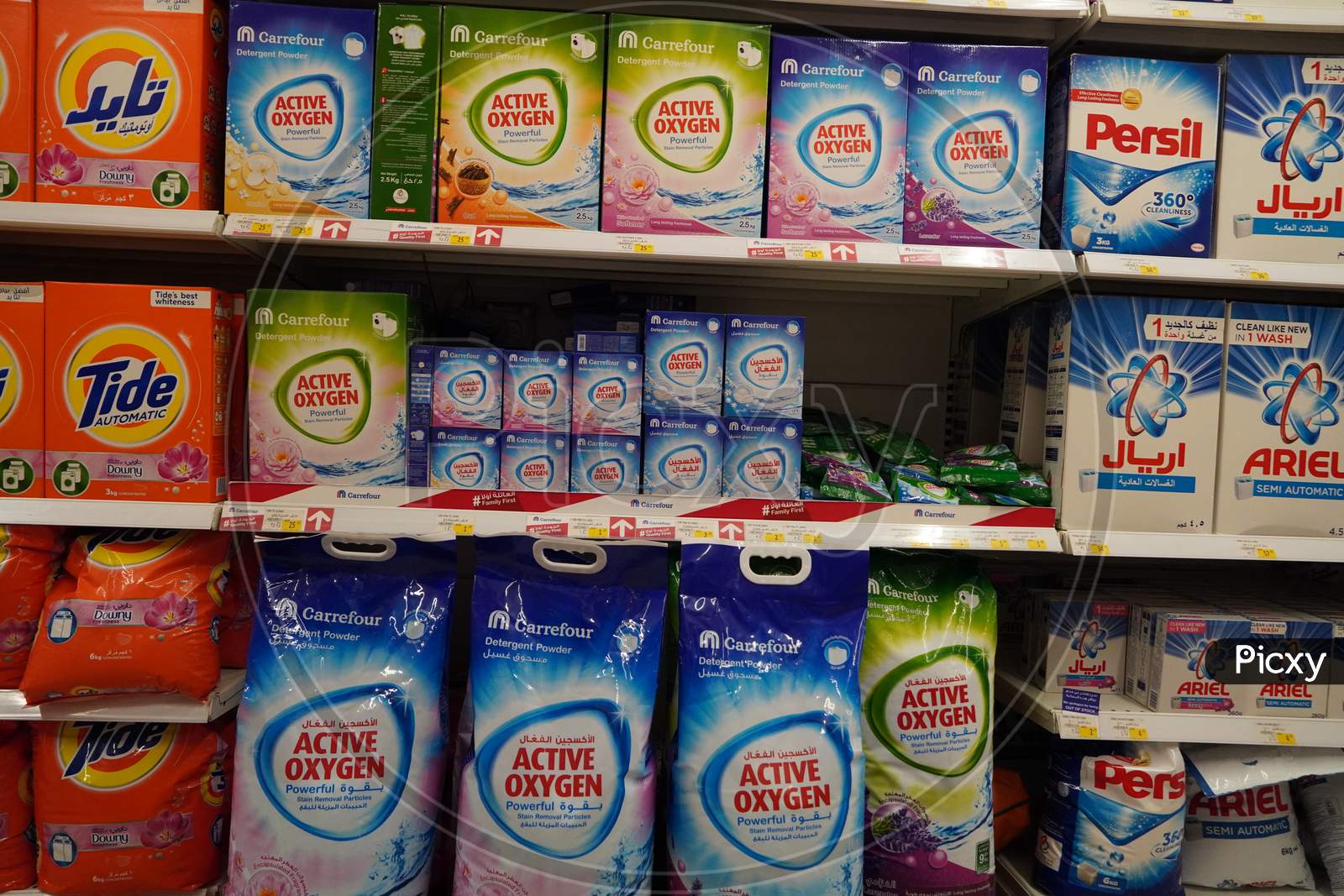 Supermarket Display With Different Brands Of Washing Powder In Boxes. Wholesale. Tide, Ariel, Omo Laundry Detergent Boxes Lined Up For Sale In A Store Shelf- Dubai Uae December 2019