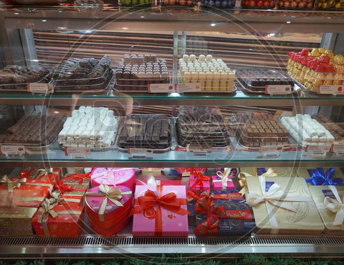 Close Up Of Several Chocolate Sweets In A Shop. Chocolate Candy In A Store Window. Stand With Chocolates. Collection Of Delicious Chocolate Candies With Different Fillings. - Dubai Uae December 2019