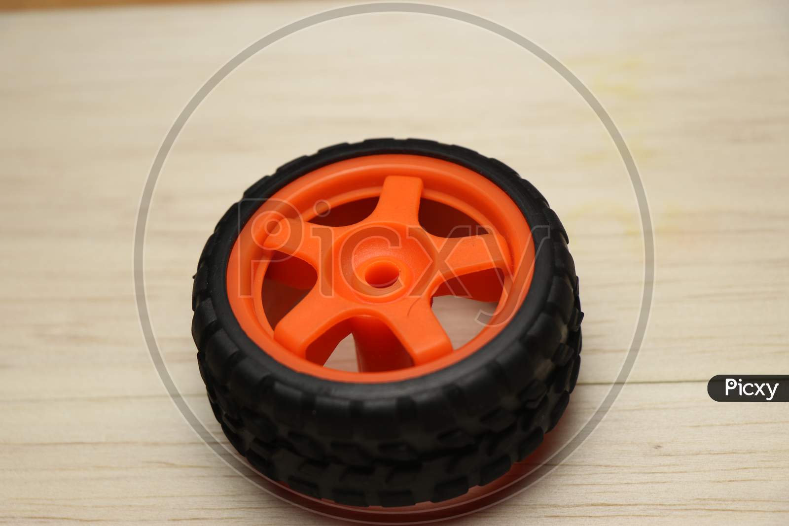 Wheel Of Radio Controlled Car On A Wooden Background