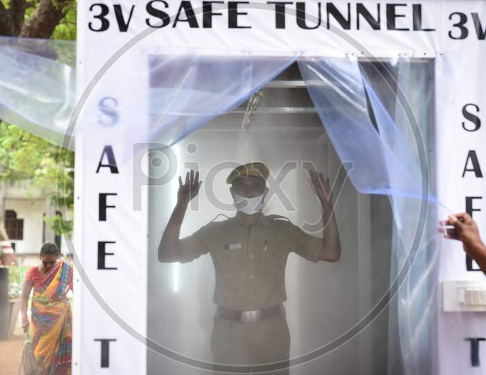 A Policeman Stands Inside A Disinfection Tunnel Installed At The Entrance Of The Police Commissioner Office During The Nationwide Lockdown Imposed In The Wake Of Coronavirus, In Vijayawada.