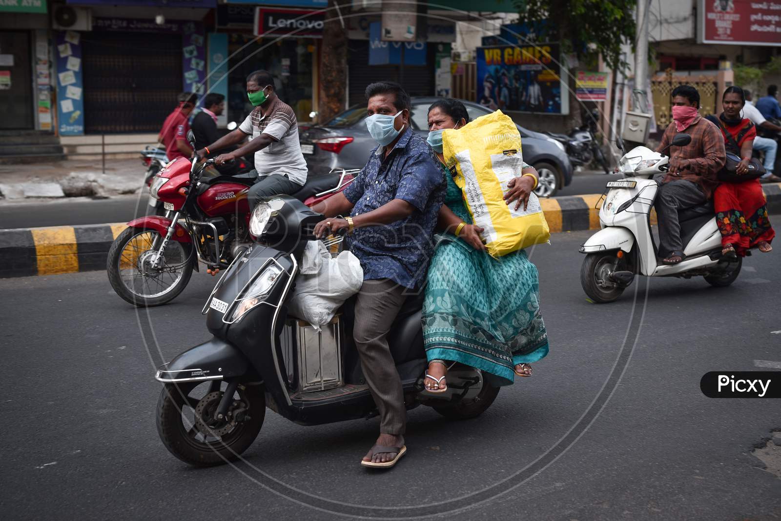 People Carry Daily Essentials On A Two-Wheeler During The Nationwide Lockdown Imposed In The Wake Of Coronavirus, In Vijayawada.