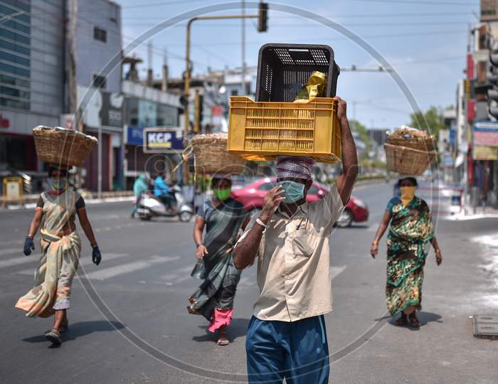 Fruit And Vegetable Sellers Wearing Face Masks Cross A Road During The Nationwide Lockdown Imposed In The Wake Of Coronavirus, In Vijayawada.