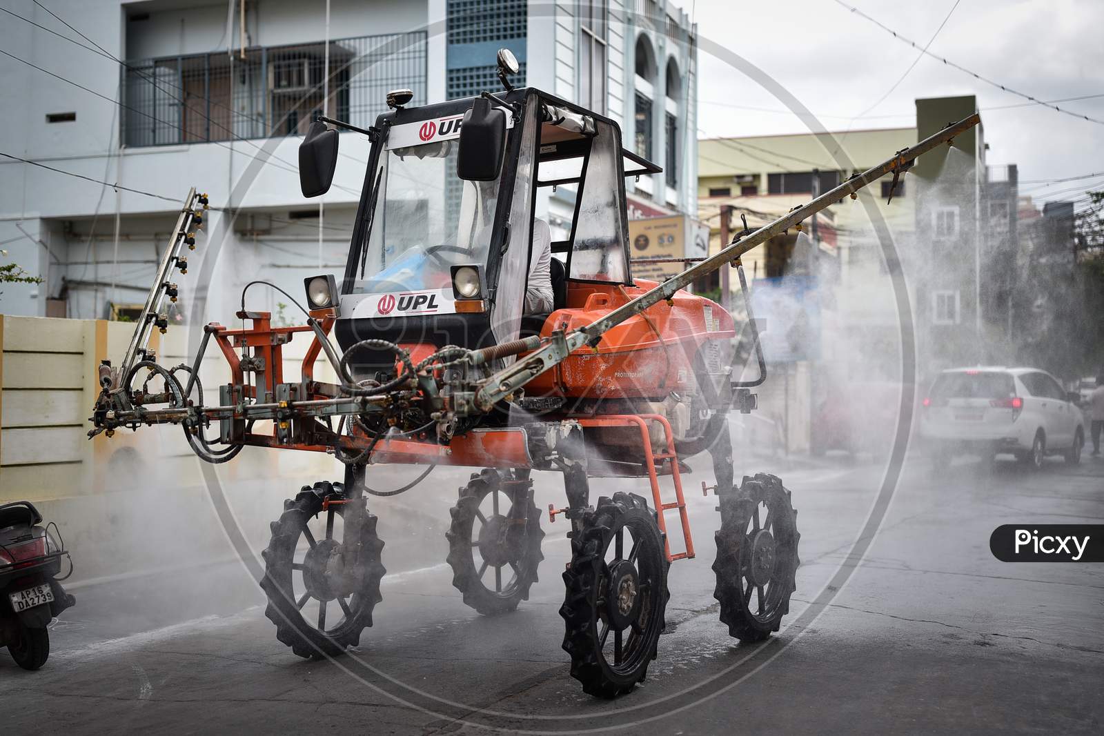 A Corporation Vehicle Sprays Disinfectant As A Precautionary Measure To Prevent The Spread Of Coronavirus, At A Covid-19 Contaminated Zone During The Nationwide Lockdown Imposed In The Wake Of Coronavirus, In Vijayawada.