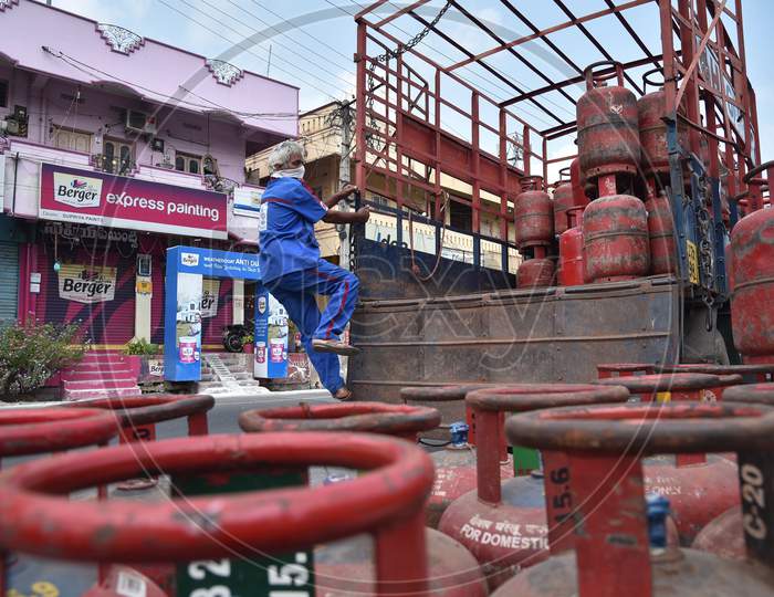 A Worker Gets Down From A Vehicle Loaded With Lpg Cylinders During The Nationwide Lockdown Imposed In The Wake Of Coronavirus, In Vijayawada.