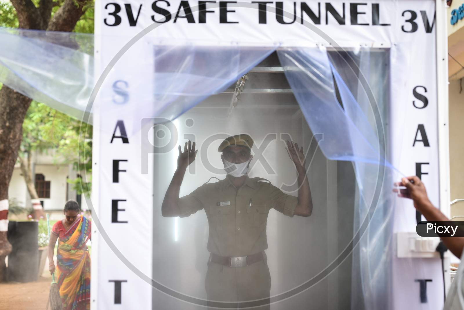 A Policeman Stands Inside A Disinfection Tunnel Installed At The Entrance Of The Police Commissioner Office During The Nationwide Lockdown Imposed In The Wake Of Coronavirus, In Vijayawada.