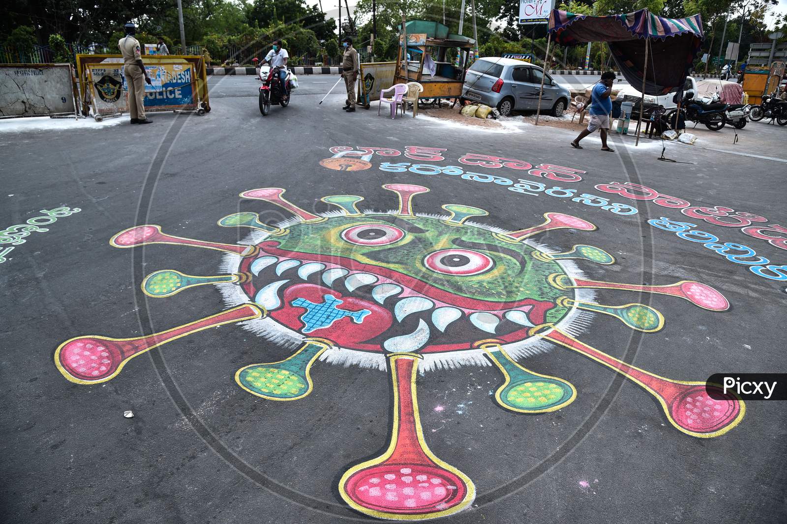 A Coronavirus Graffiti Is Seen On A Road During The Nationwide Lockdown Imposed In The Wake Of Coronavirus, In Vijayawada.