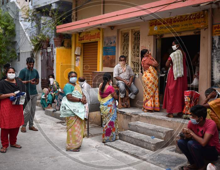 People Wait Outside A Ration Store At A Covid-19 Contaminated Zone During The Nationwide Lockdown Imposed In The Wake Of Coronavirus, In Vijayawada.
