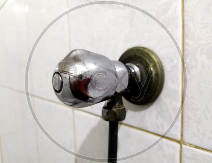 steel tap in bathroom wall