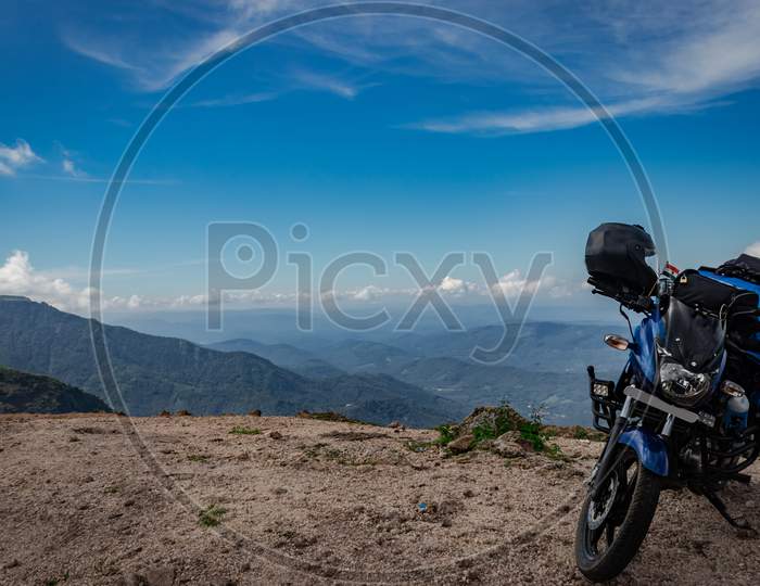Solo Traveler Loaded Bike With Amazing Background On Hilltop