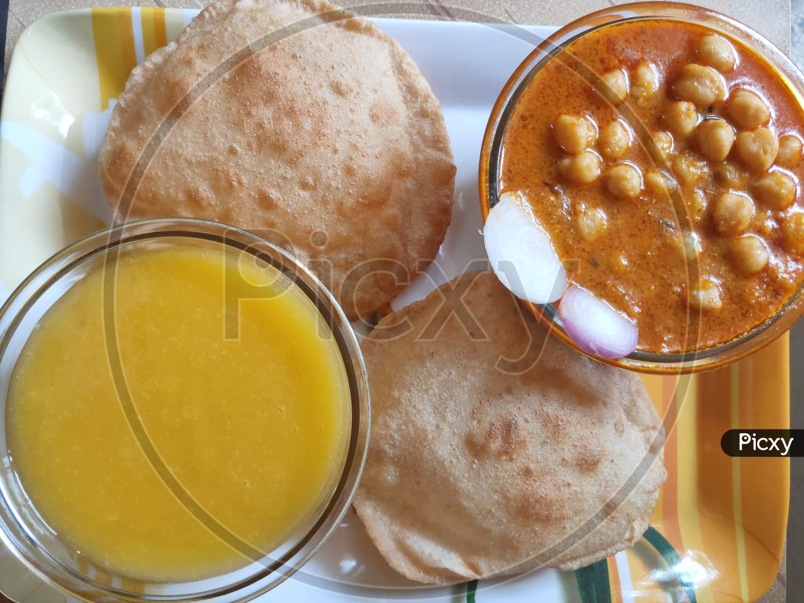 Chole Poori and Mango juice. Chickpeas receipe and Mango juice. Chole Puri in a plate.
