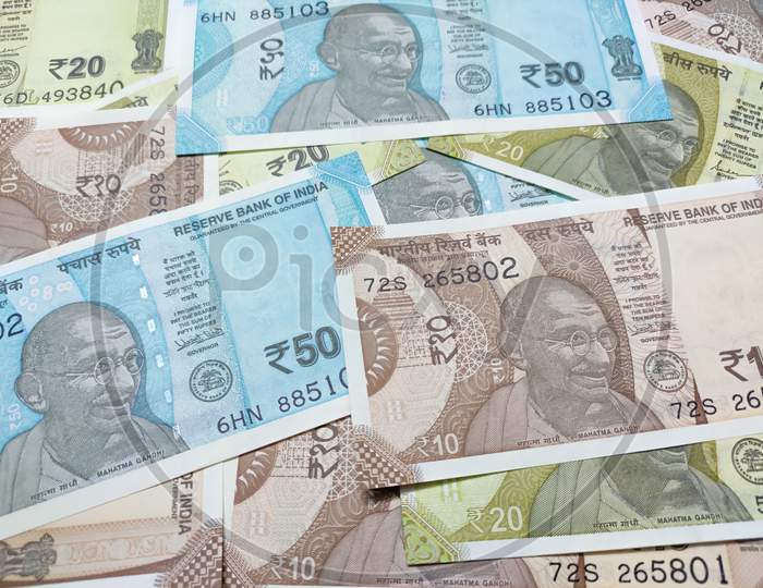 Close up view of many Indian rupee banknotes. New Indian colorful banknotes currency