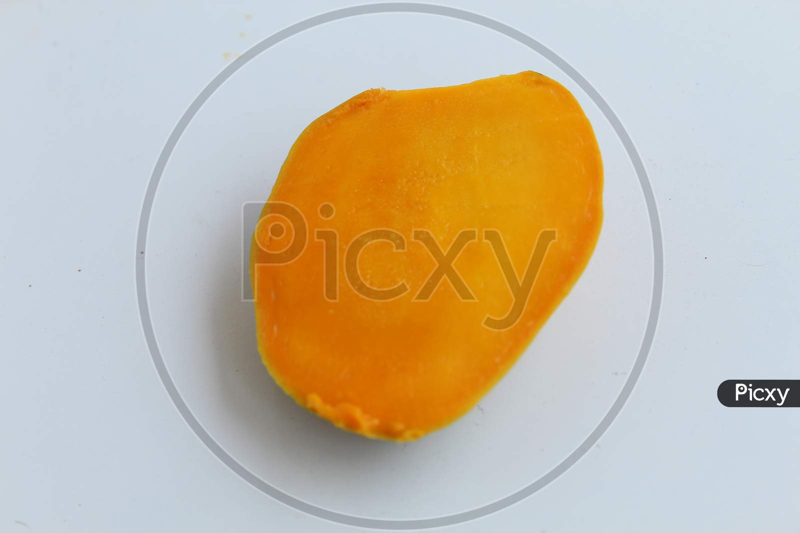 Juicy ripe Mango slice isolated