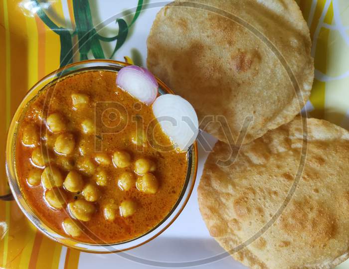 Chole Poori dish. Chickpeas receipe and Poori. Chana masala receipe and Puri in a plate.