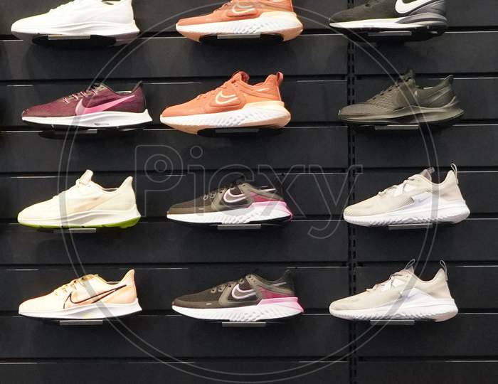 Shop Display Of A Lot Of Sports Shoes On A Wall. A View Of A Wall Of Shoes Inside The Store. Modern New Stylish Sneakers Running Shoes For Men And Women - Dubai Uae December 2019