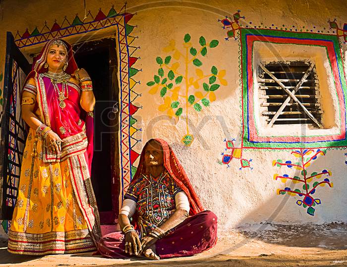 Jaisalmer, Rajasthan, India - April 18Th, 2018: Indian Village Women Outside Their House Wearing Ethnic Traditional Outfits, Village Life Concept