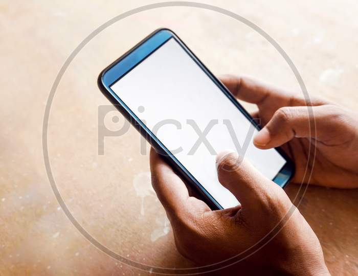 hand holding smart phone with white screen