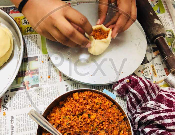 Hands Of A Lady Cooking Kachori Famous Indian Street Food , Breakfast Made With Flour Stuffed With Lintels And Spices