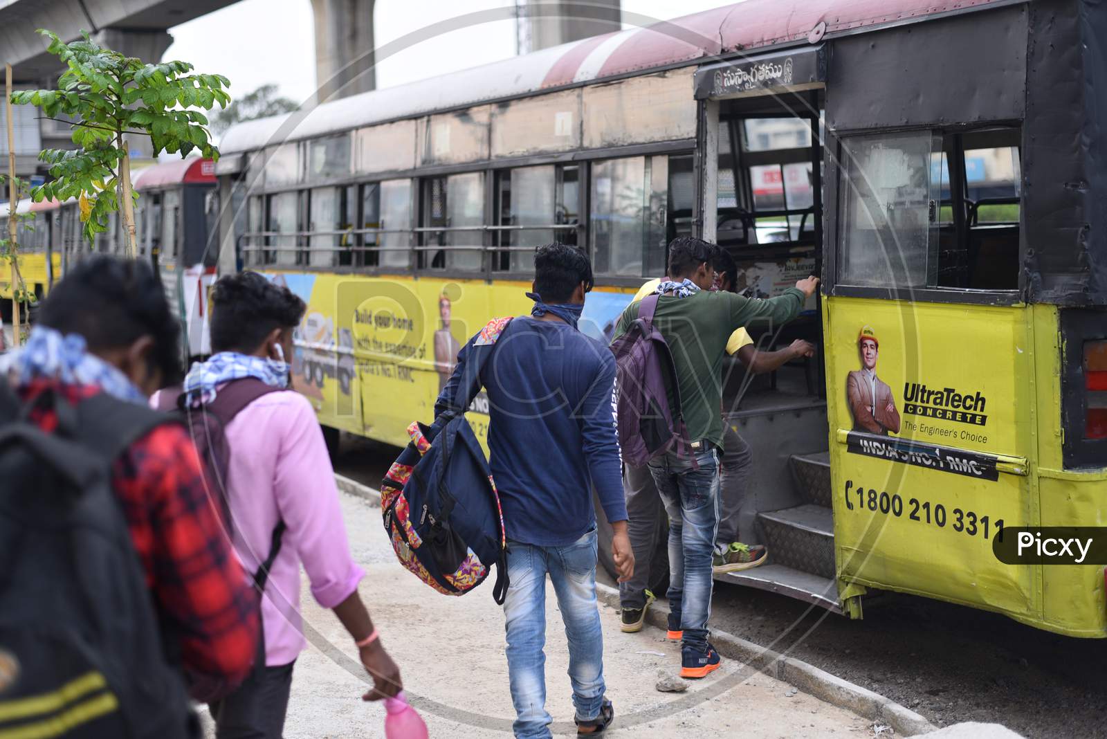 Migrant Workers from Bihar, Jharkhand and UP get into a bus after registering from Cyberabad Police to get onto a Shramik Special Train during ongoing Nationwide Lockdown amid Coronavirus Pandemic, Kukatpally,Hyderabad, May 19,2020.