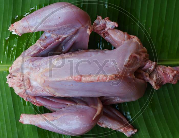 fresh full chicken meat on the banana leaf ,ready to cook,raw chicken