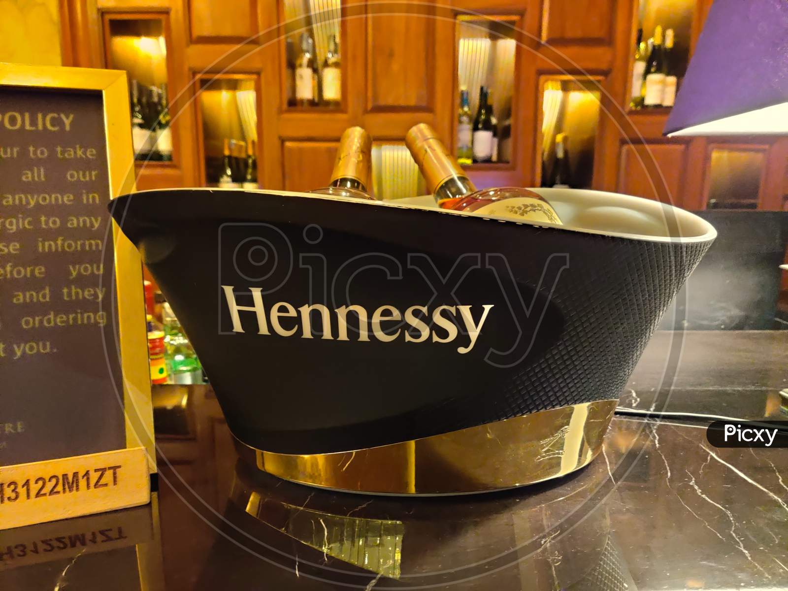 Photograph Of A Case Of Hennessy Wiskey Case On A Ornate Table