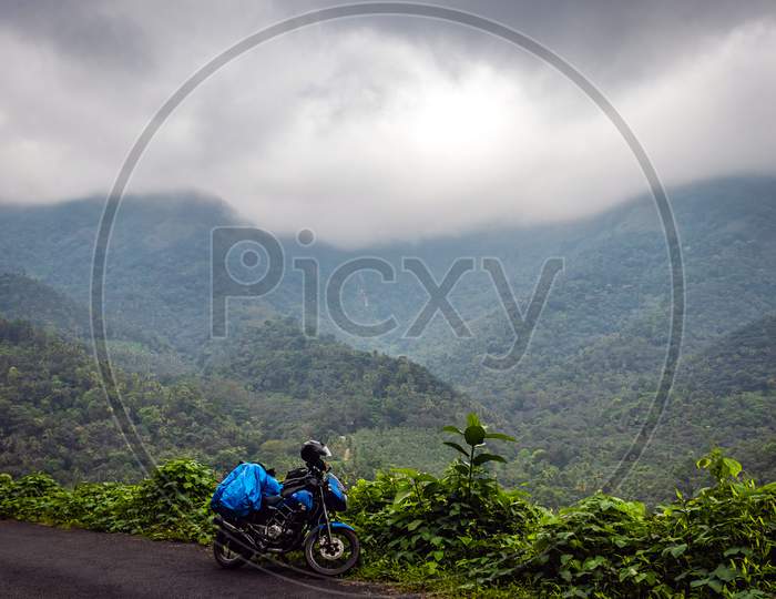 Solo Traveller Ridding Motorcycle In Hills