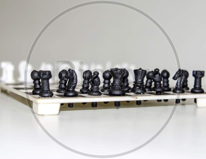 Chess board with figures on isolate white background.