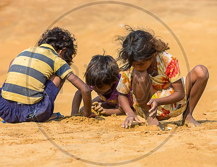 Jodhpur, Rajasthan, India - June 18Th, 2019: Poor Rural Kids Playing With Sand In Hot Summer, Unprivileged Indian Children.