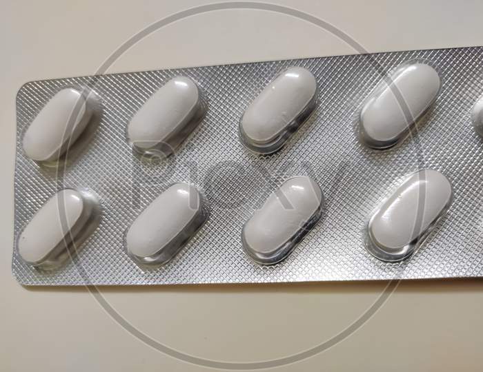 Blister packs antibiotics and pills top view. White drug blister packaging