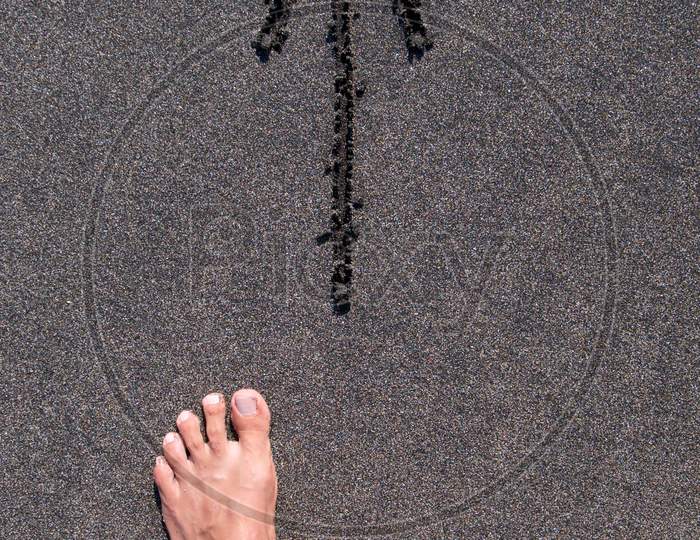 Male Feet Walking In Front Of A Direction Arrow