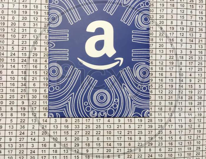 Amazon gift card with numbers background, which allows the recipient to purchase items from the Amazon.com website