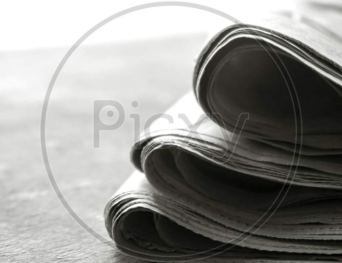 rolled up newspaper stack background