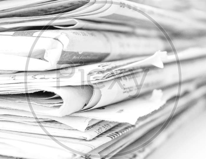 rolled up newspaper stack background
